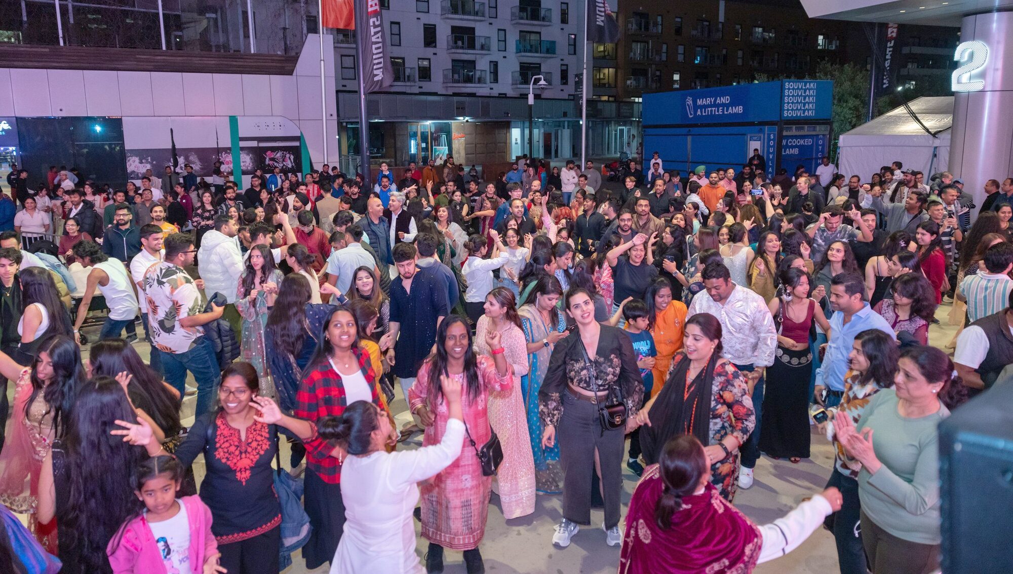 A packed evening crowd dancing at Melbourne Diwali, Marvel Stadium Square